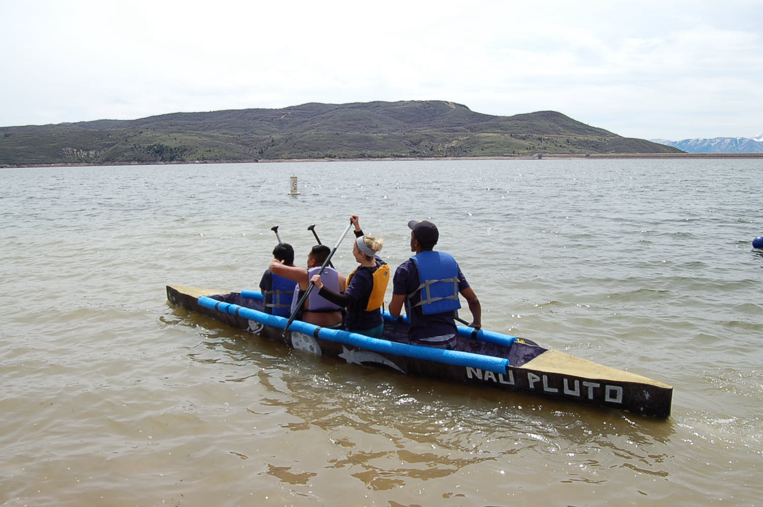 NAU PLUTO canoe on water with paddlers